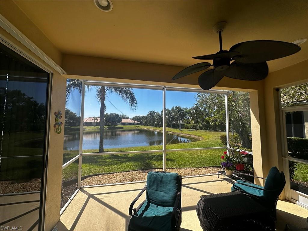 Sunroom / solarium featuring a water view and ceiling fan