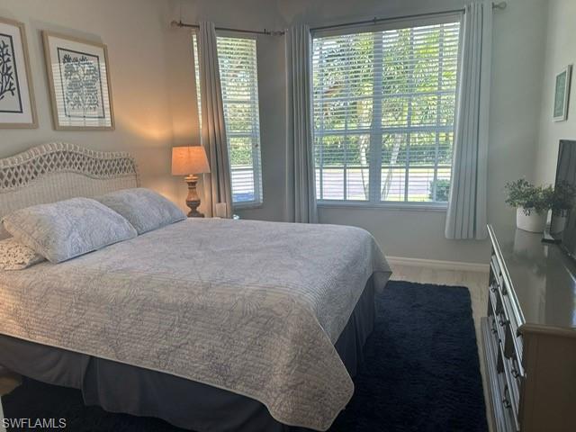 Bedroom with baseboards and wood finished floors