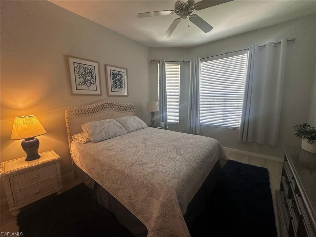 Bedroom featuring ceiling fan and baseboards