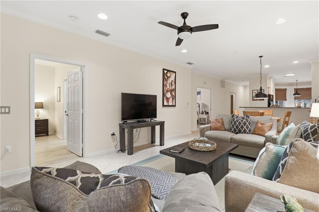 Living area with crown molding, recessed lighting, a ceiling fan, and light tile patterned floors