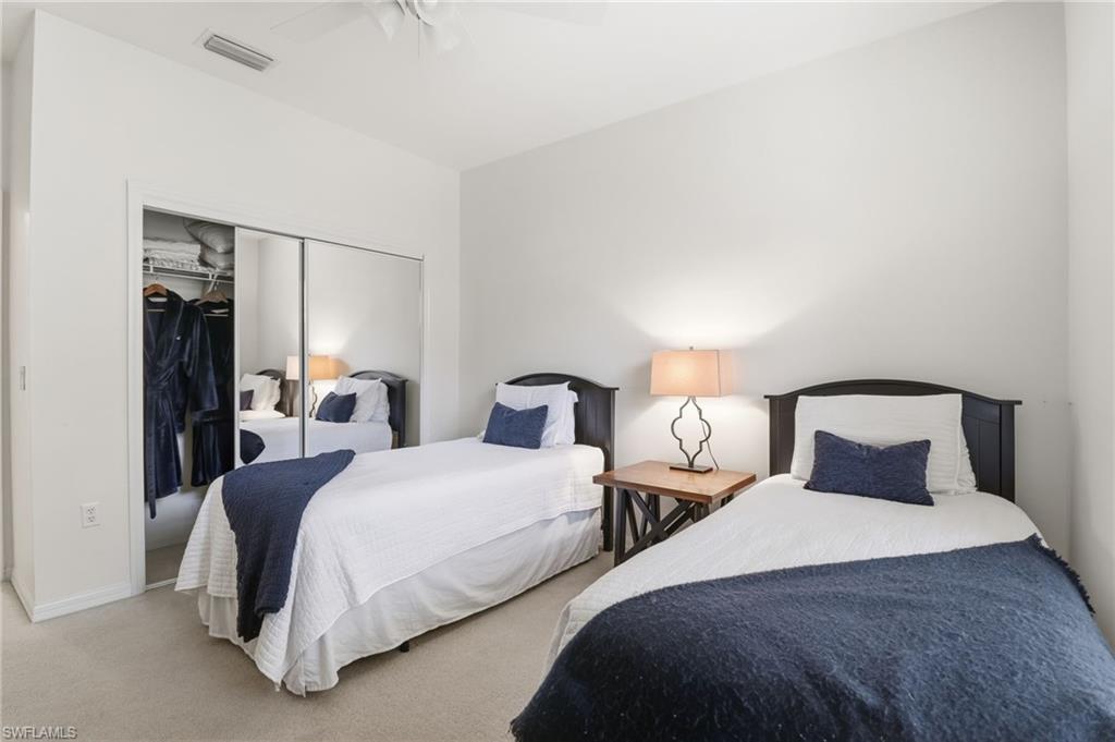 Bedroom featuring a closet and two twin beds