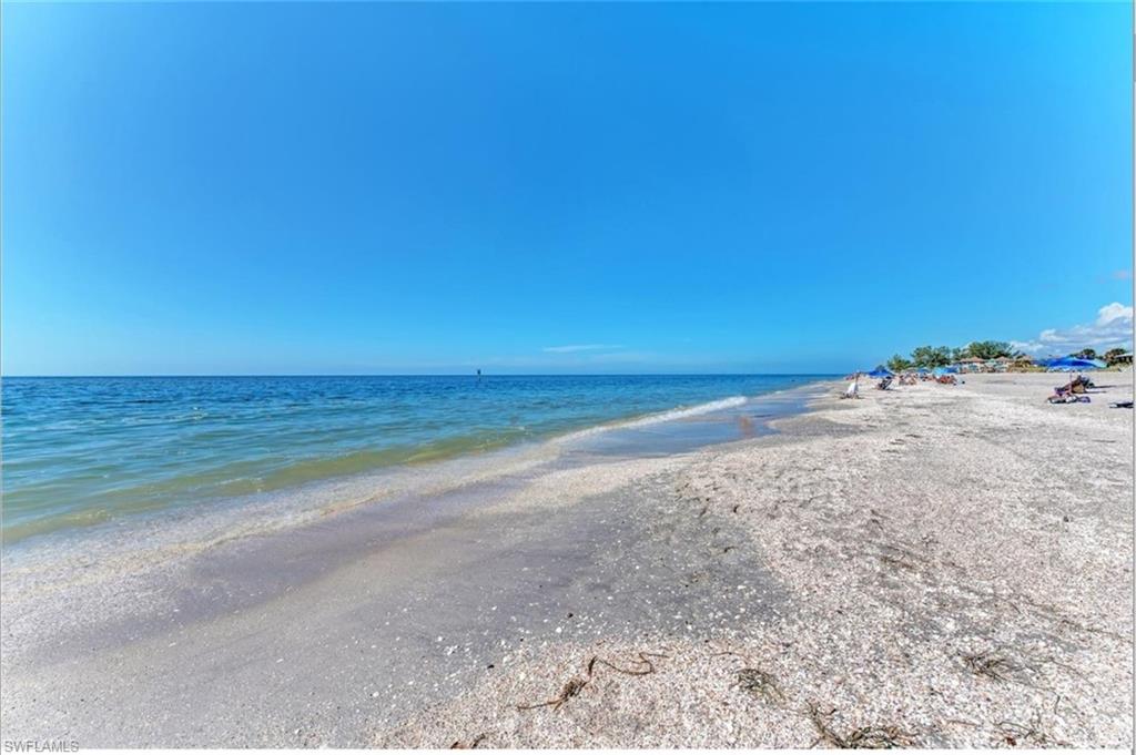 Expansive beachfront with calm ocean waters and a clear horizon