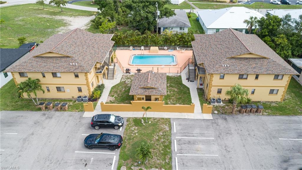 Community featuring two multi-story buildings, a central swimming pool, and a dedicated parking lot