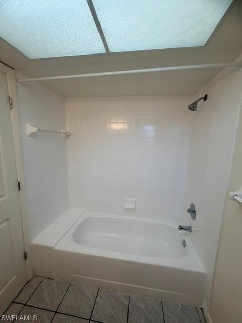 White tub and shower combination with subway tile surround