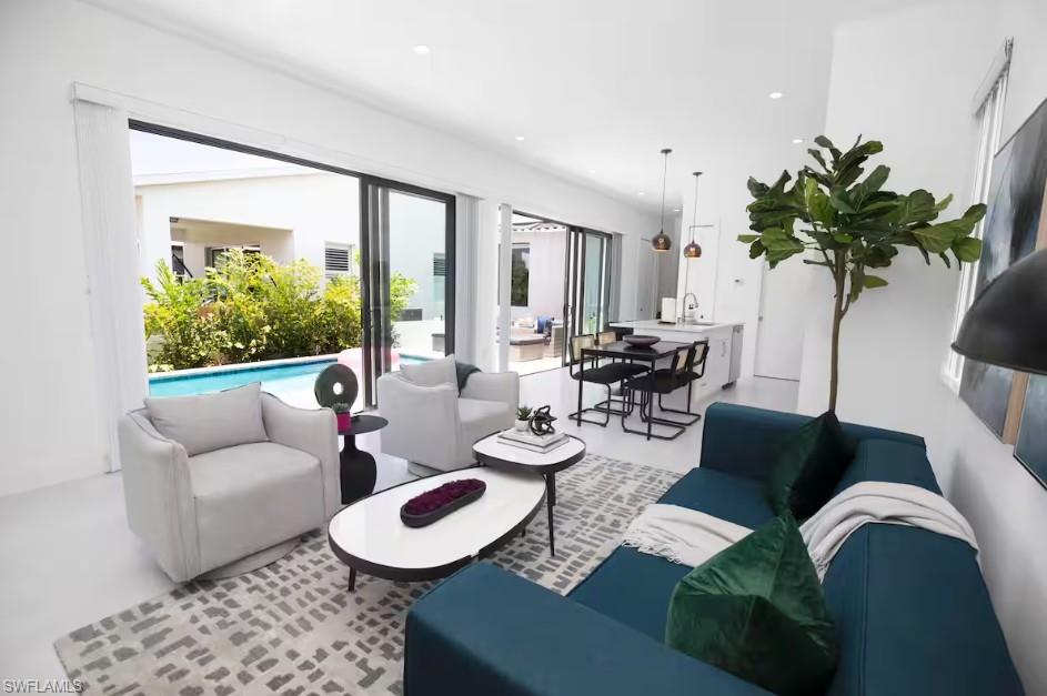 Open-concept living space with swimming pool view