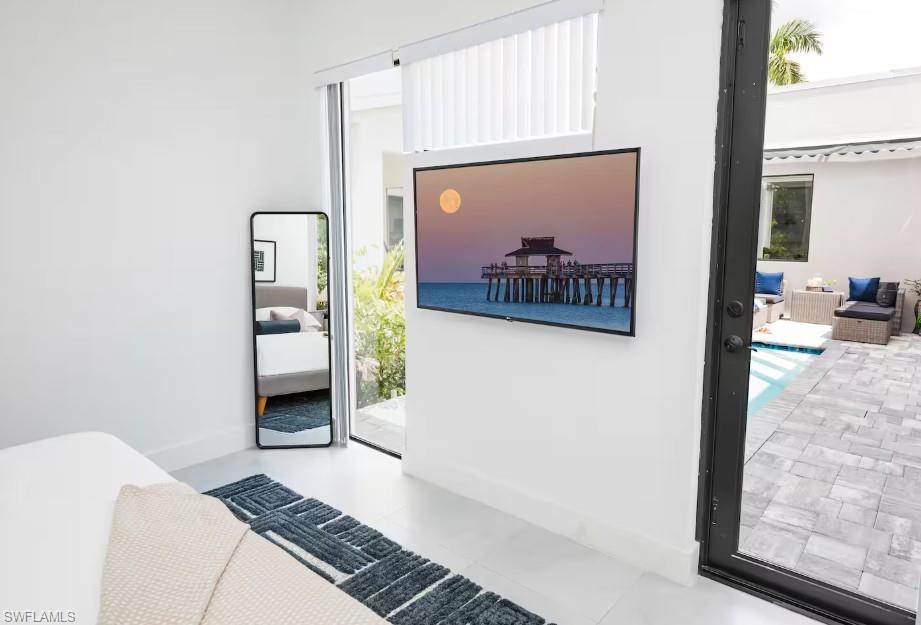 Master bedroom with a swimming pool view