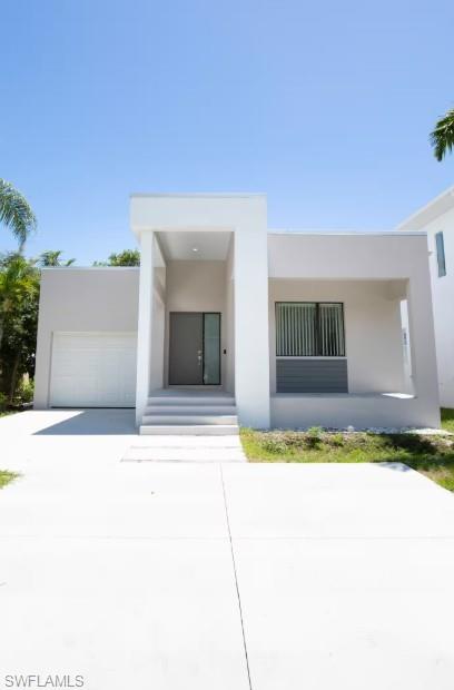 The front yard, garage, space for parking