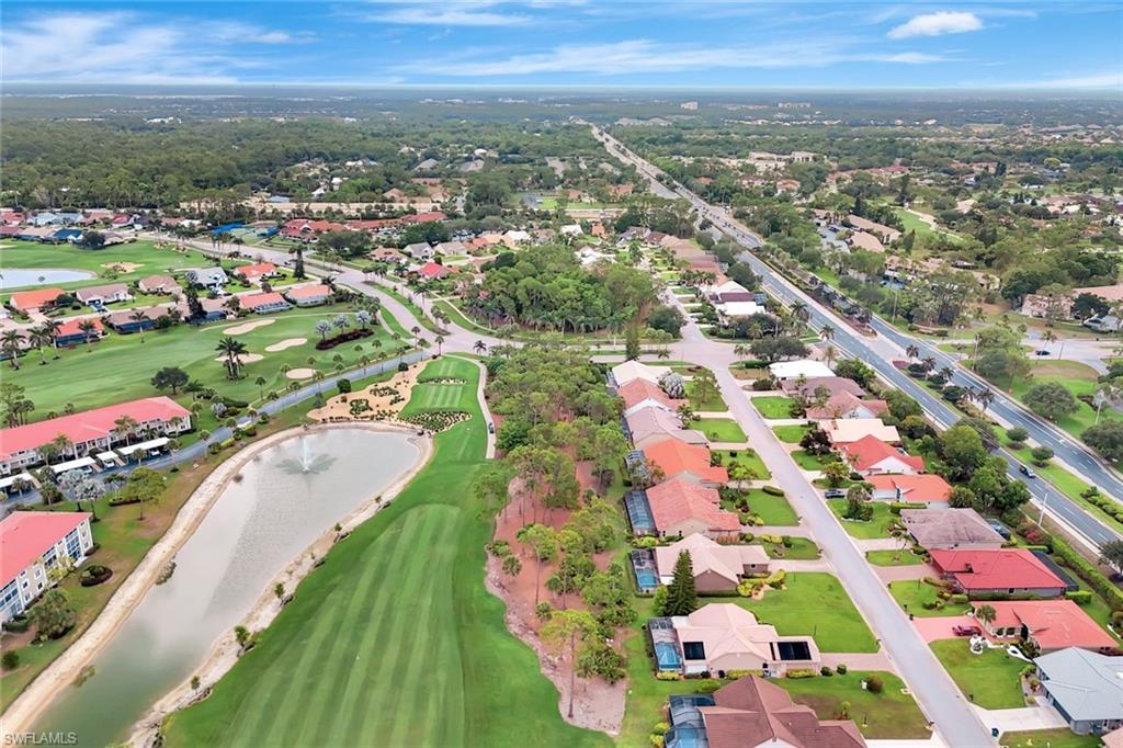 Aerial view of residential area with a large body of water and a golf course