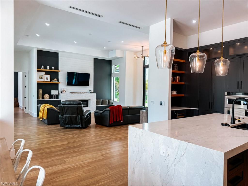 Open-concept living space featuring wood-finish flooring