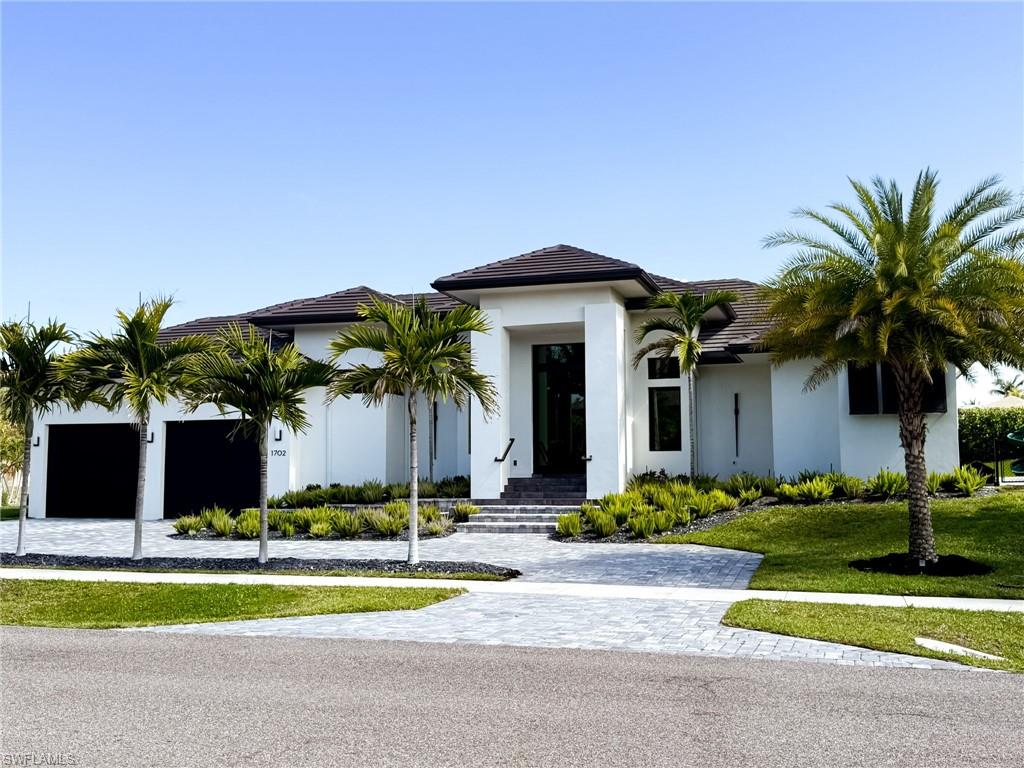 Contemporary stucco exterior with a dark tile roof
