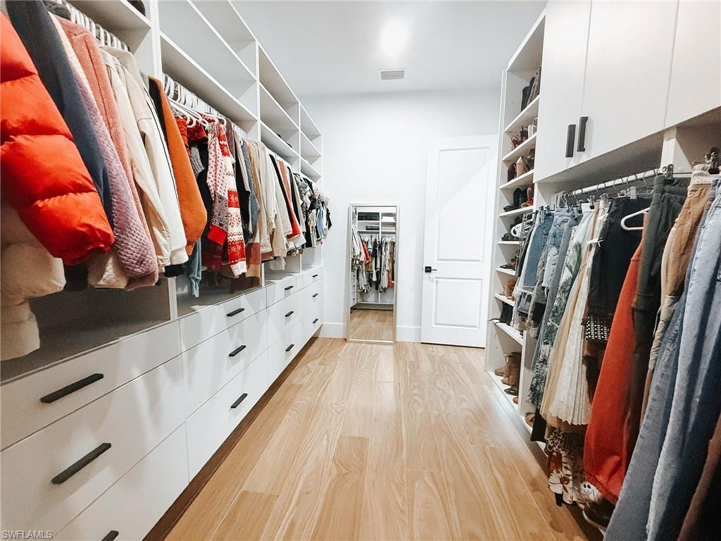 Custom built-in closet system featuring extensive storage solutions