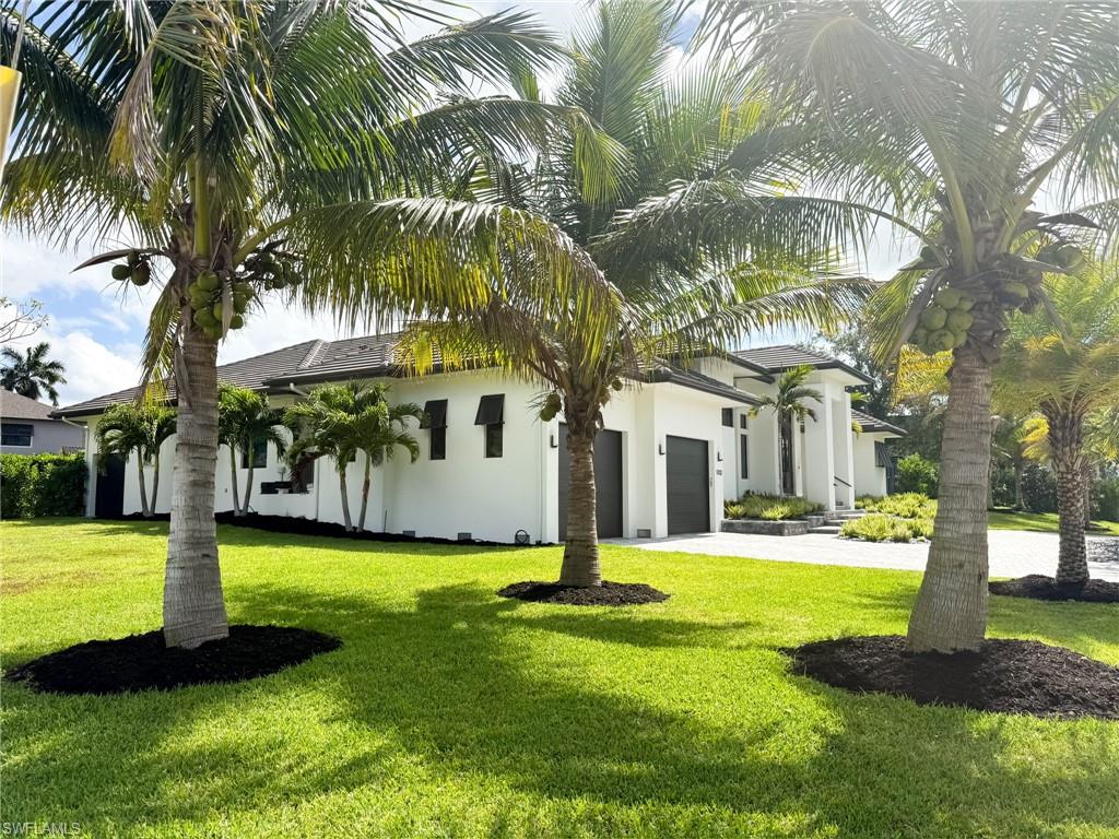Contemporary white stucco residence with a dark roofline