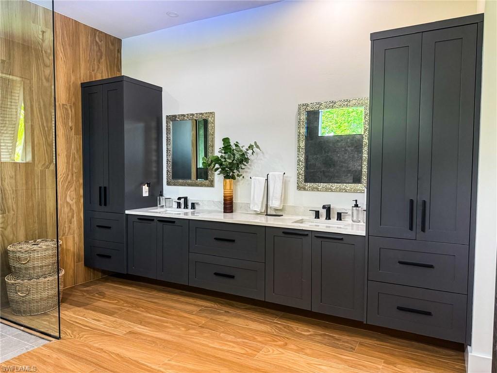 Dual vanities with undermount sinks, quartz countertops, and matte black fixtures