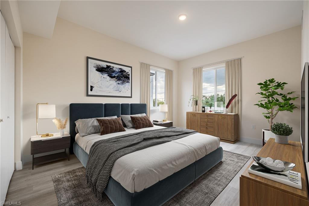 Bedroom with light wood finished floors, baseboards, recessed lighting, and access to exterior