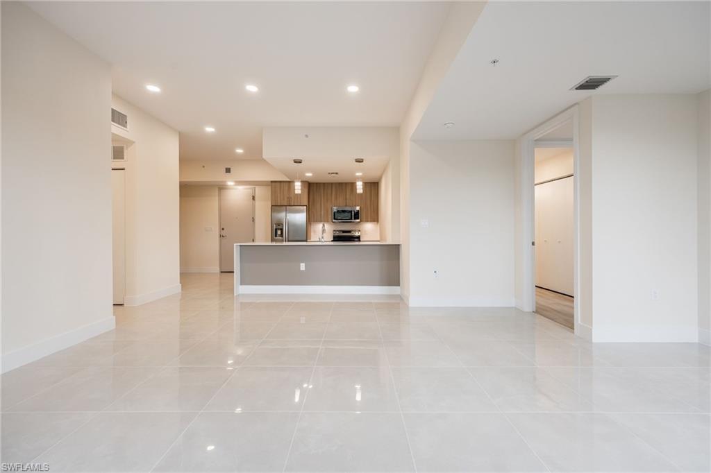 Unfurnished living room featuring visible vents, recessed lighting, and light tile patterned flooring