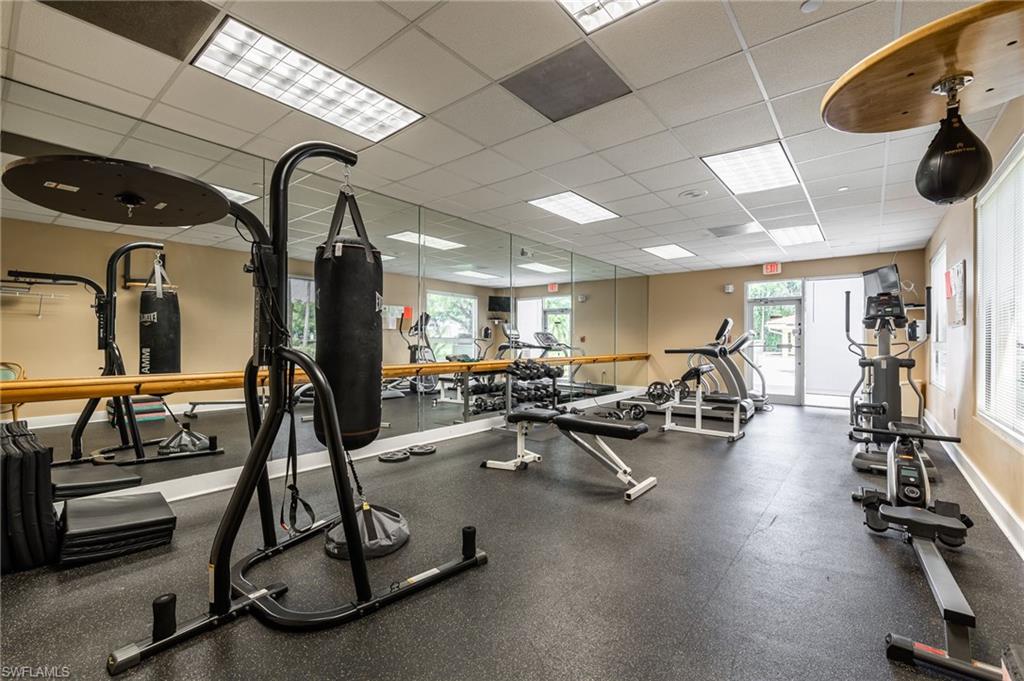 Gym with baseboards and a drop ceiling