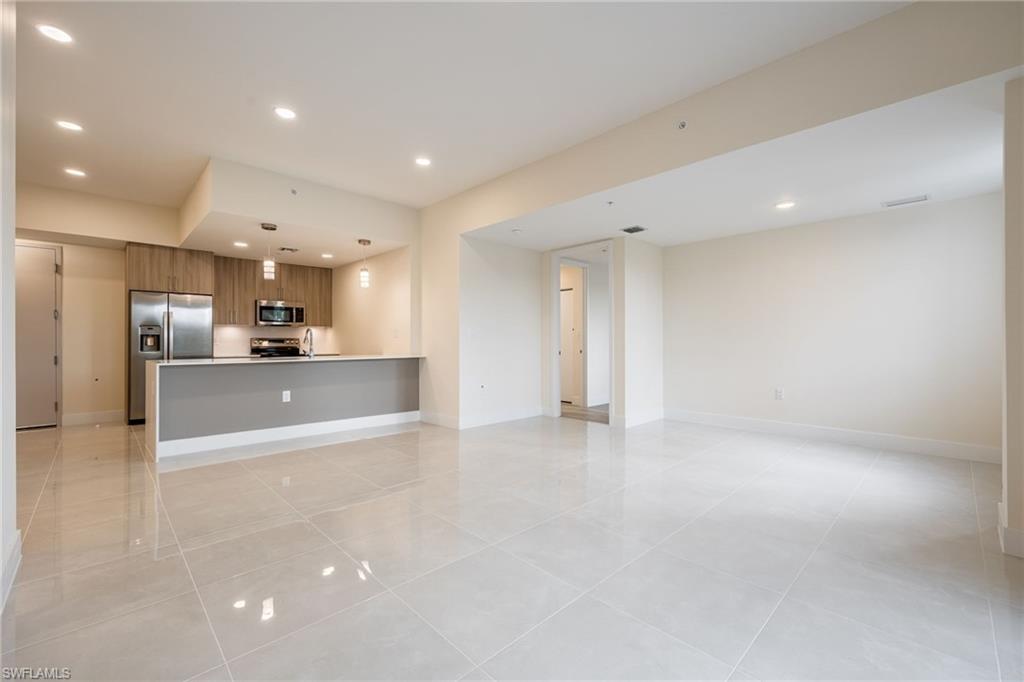 Unfurnished living room with baseboards, recessed lighting, and light tile patterned floors
