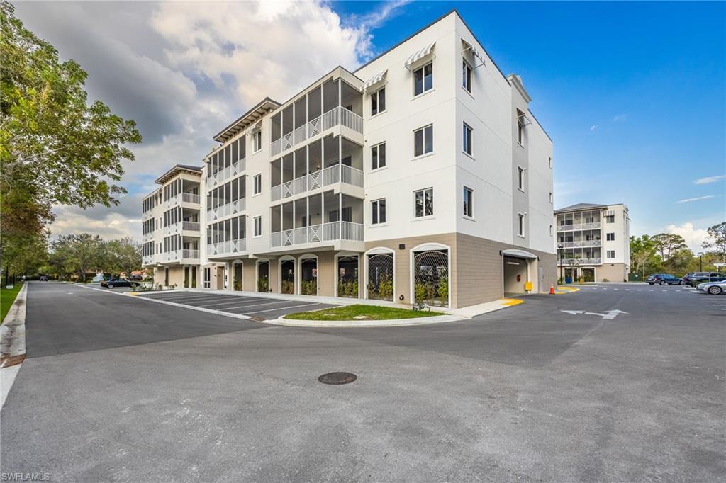 View of property featuring uncovered parking