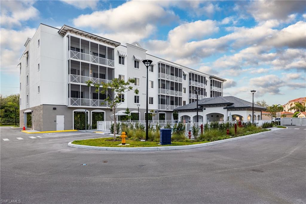 View of building exterior with central AC unit and fence