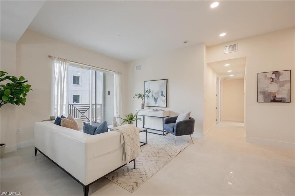 Living area featuring baseboards, visible vents, and recessed lighting