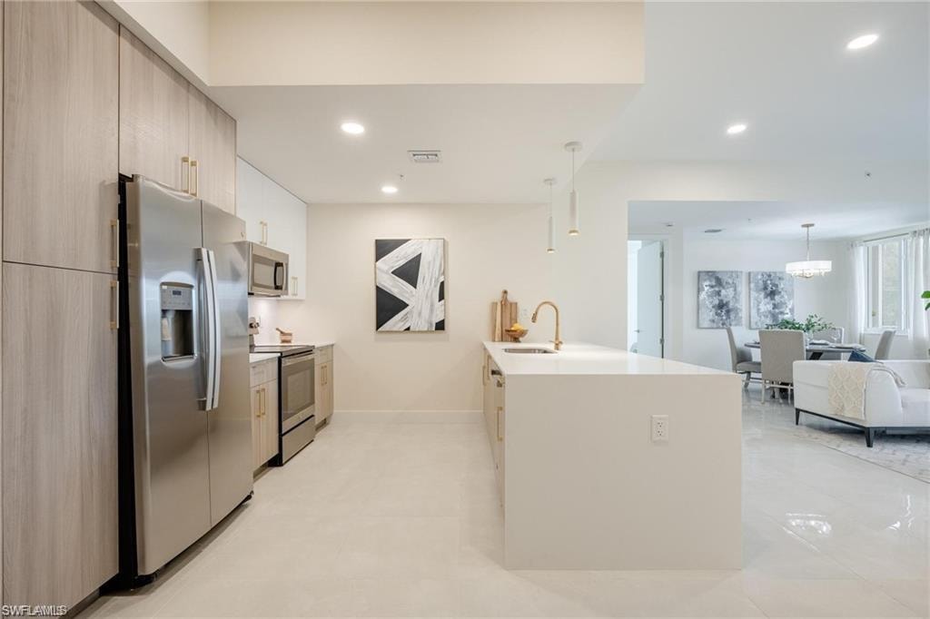 Kitchen featuring a sink, modern cabinets, stainless steel appliances, visible vents, and recessed lighting