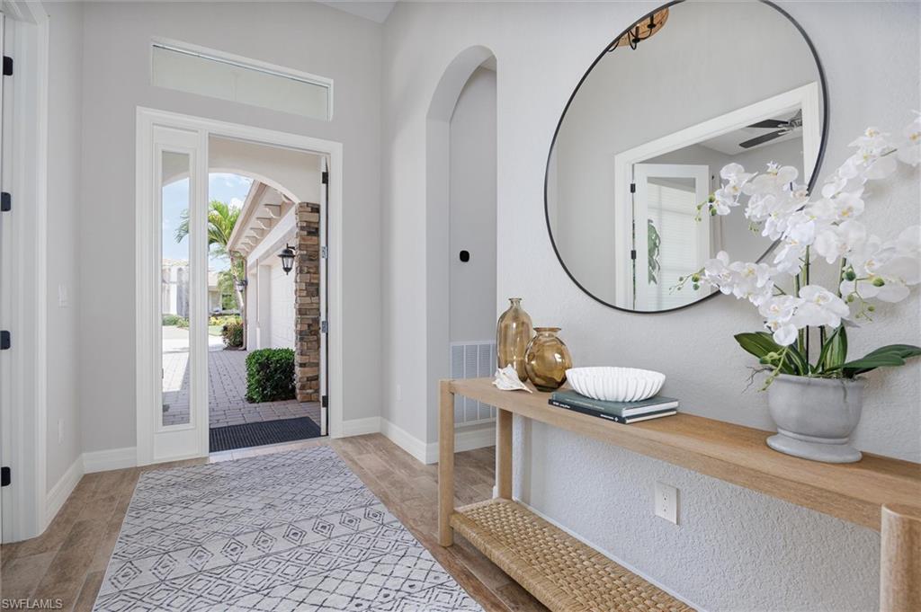 Bright entryway featuring light-toned wood-finish flooring