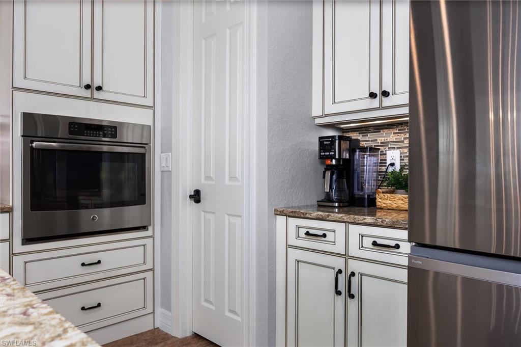 Built-in stainless steel oven with surrounding custom cabinetry