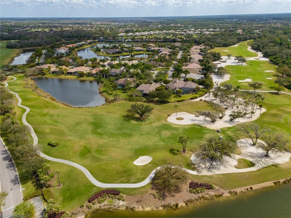 Expansive golf course setting featuring manicured greens, sand traps, and mature trees