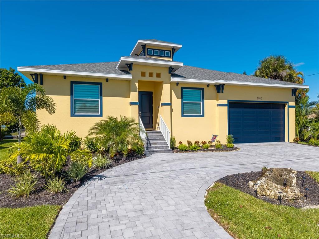 Contemporary stucco exterior with a prominent cupola