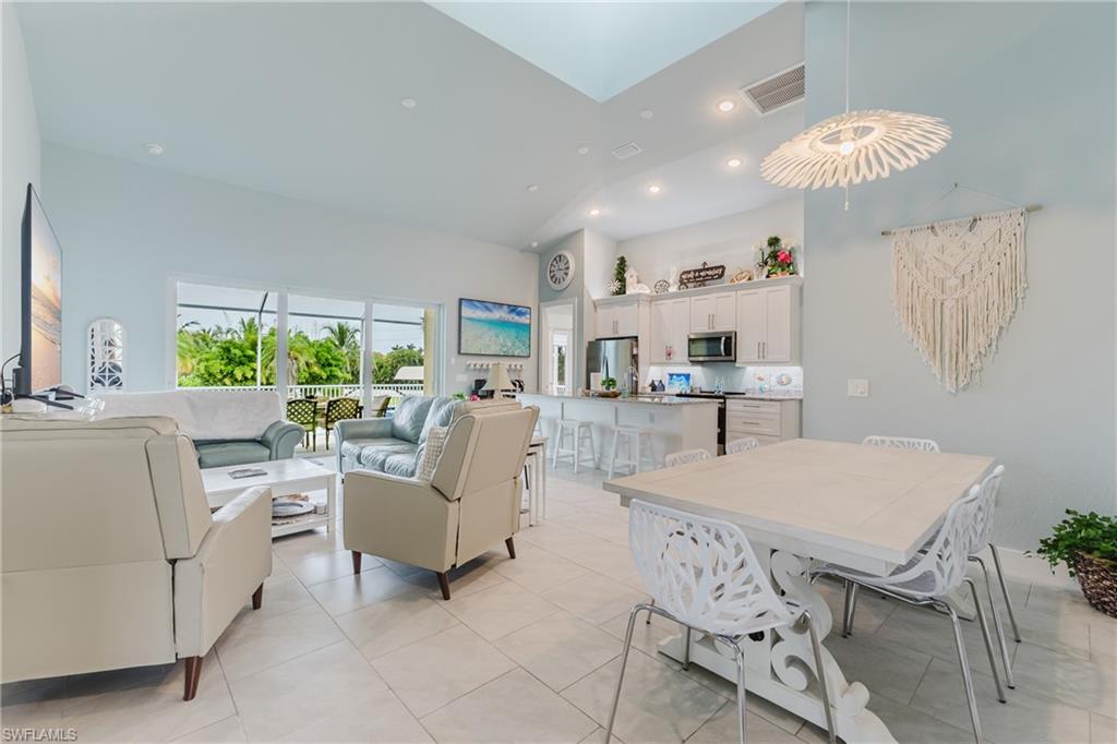 Open-concept living space featuring high ceilings and light tile flooring