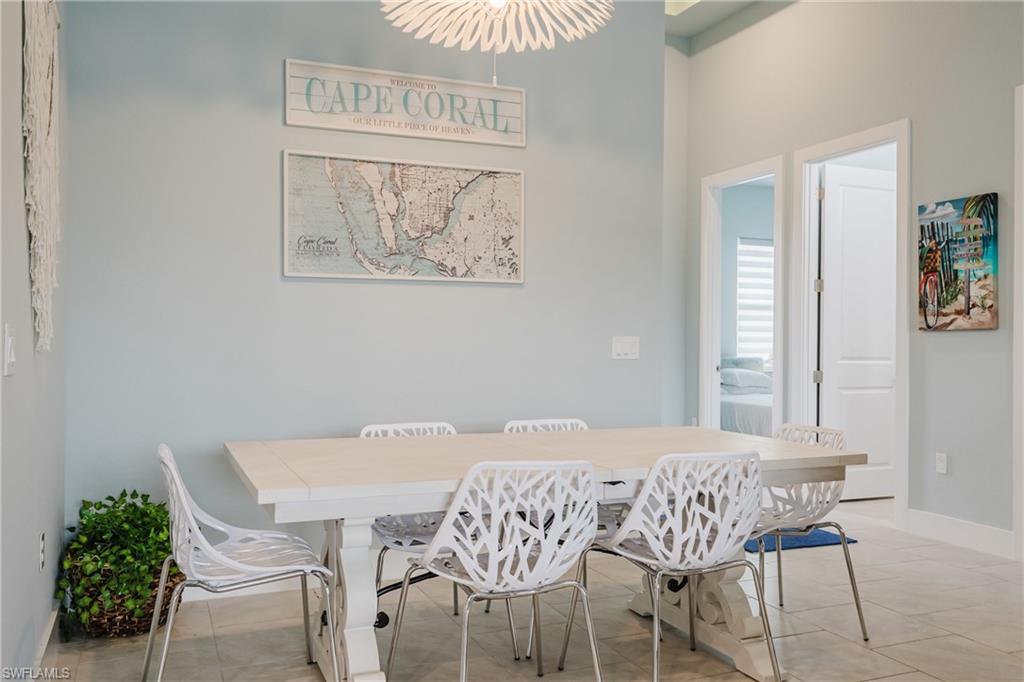 Spacious dining area featuring neutral wall tones and tile flooring