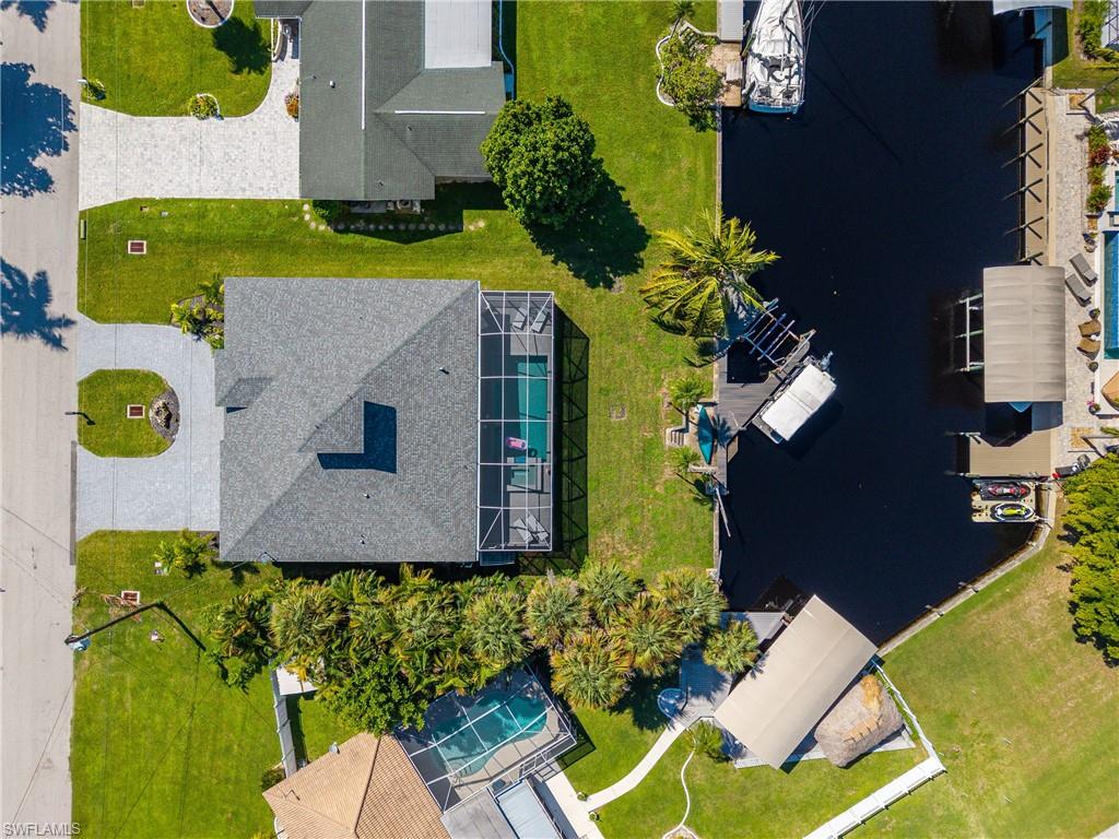 Canal-front property featuring a screened pool enclosure and private boat dock