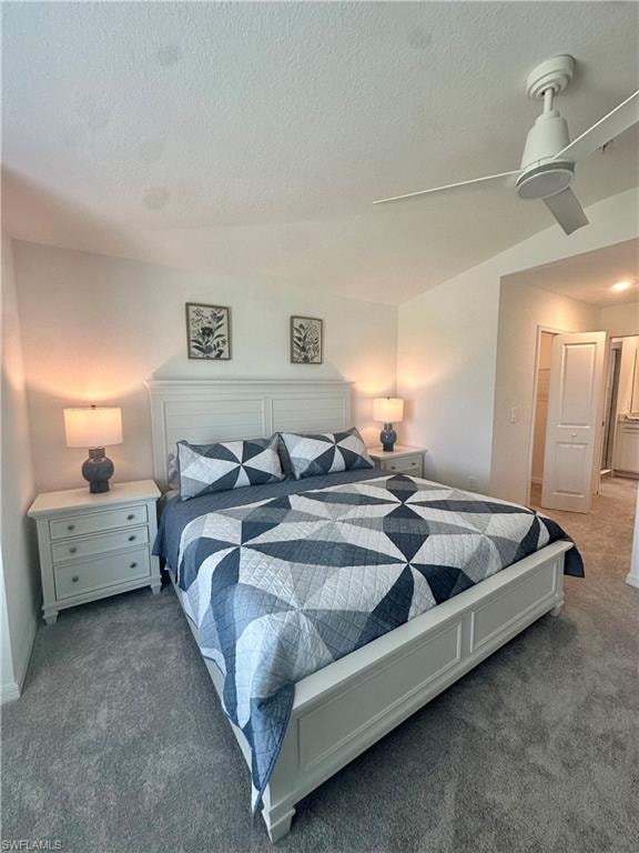 Carpeted bedroom with a textured ceiling and baseboards