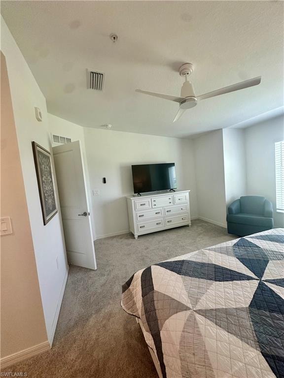 Bedroom featuring carpet floors, baseboards, and ceiling fan