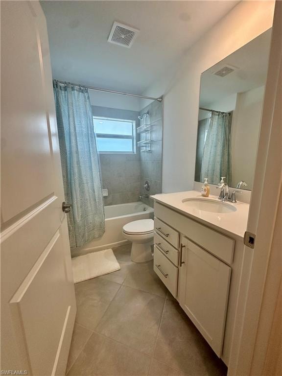 Bathroom featuring shower / bath combo, vanity, tile patterned flooring, and toilet