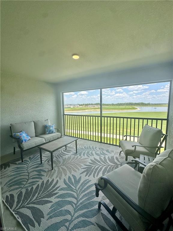 Sunroom featuring a water view