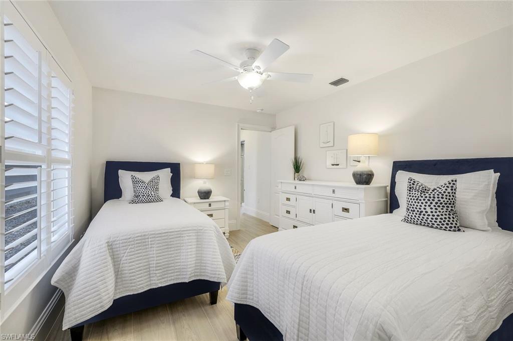 Bedroom with ceiling fan and light hardwood / wood-style flooring