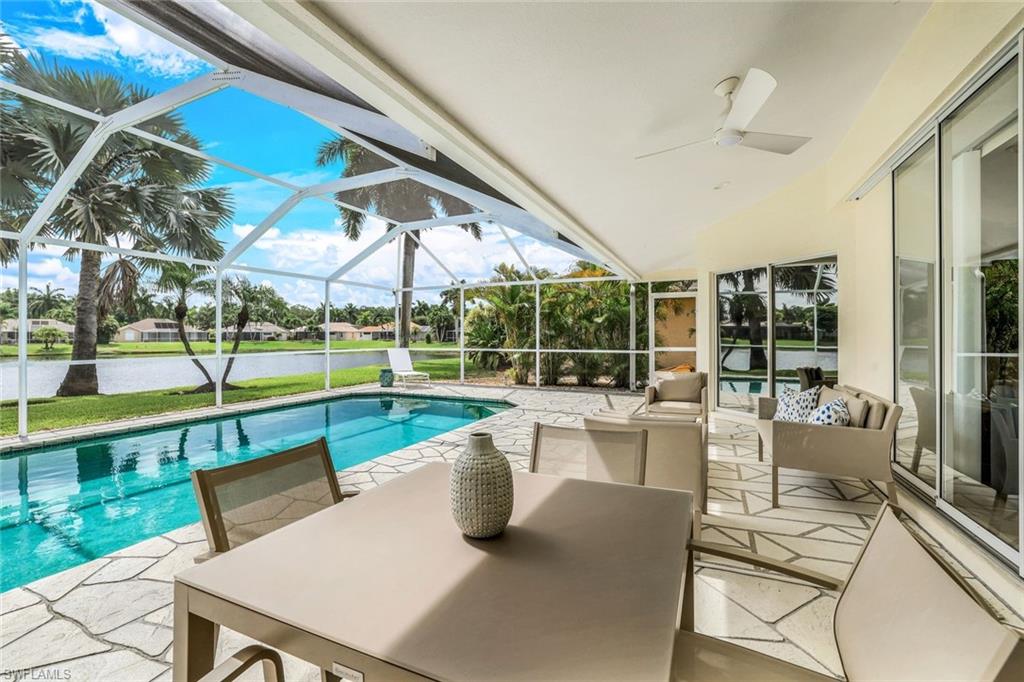 View of pool with a patio, a lawn, a lanai, and ceiling fan