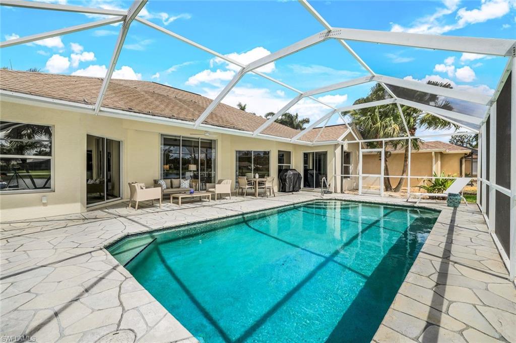 View of pool with a patio and a lanai