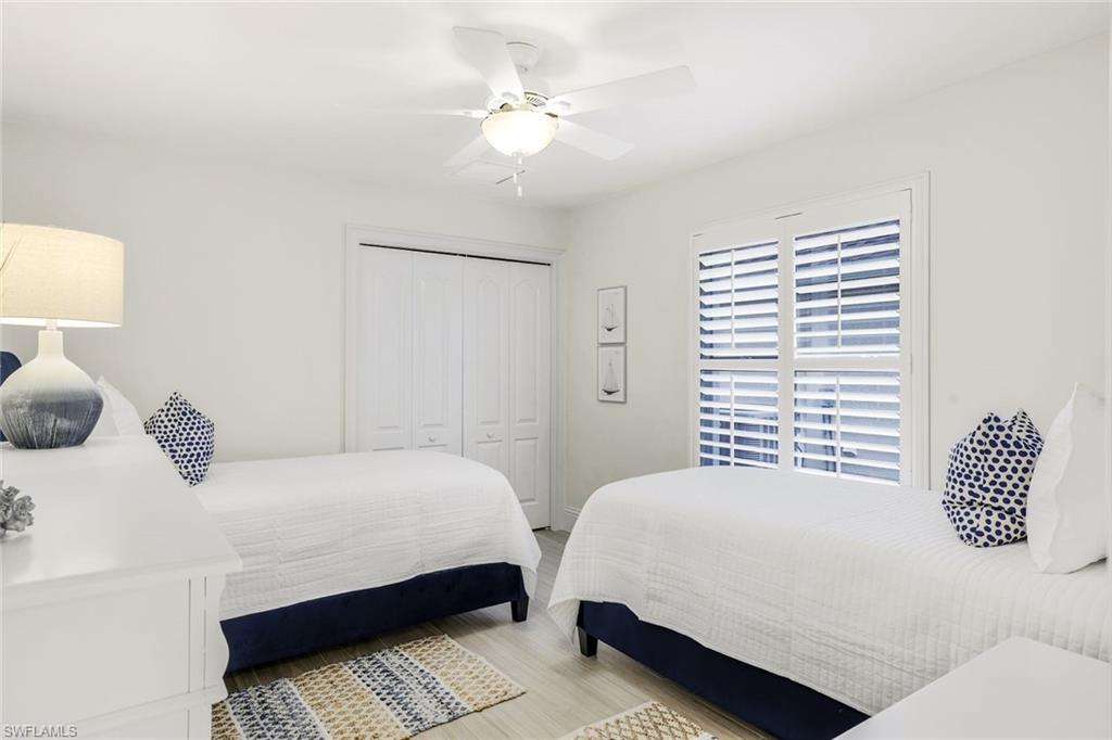 Bedroom featuring ceiling fan, a closet, and hardwood / wood-style flooring
