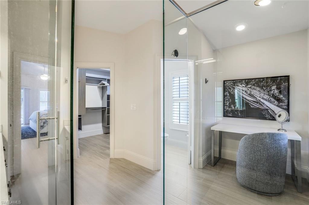 Bathroom featuring walk in shower and hardwood / wood-style floors