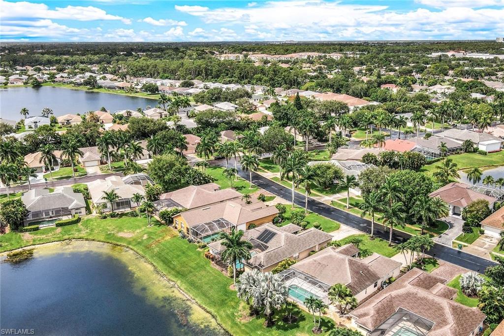 Birds eye view of property with a water view