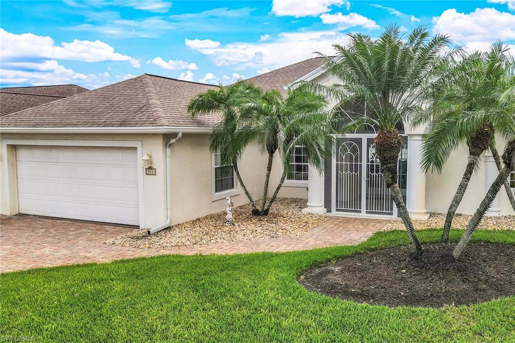 View of front facade with a garage and a front lawn