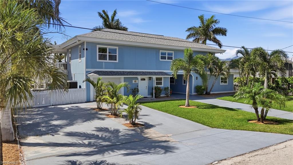 Two-story residential structure with blue siding, white trim, and a shingle roof - Virtually Edited Image