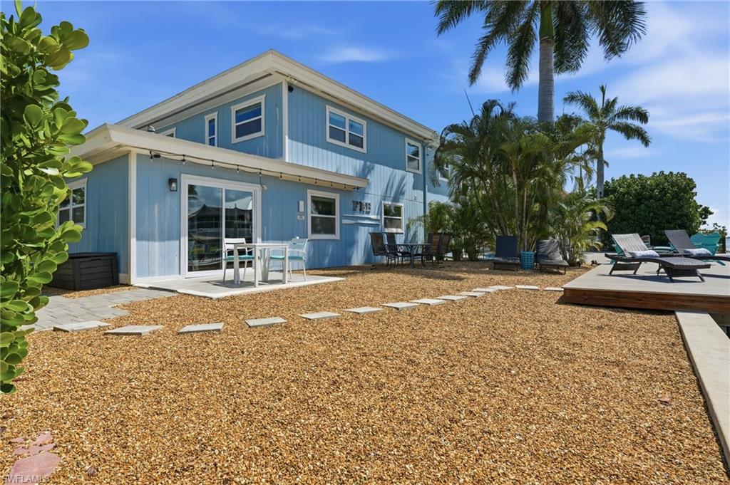 Two-story exterior with light blue siding and white trim - Virtually Edited Image