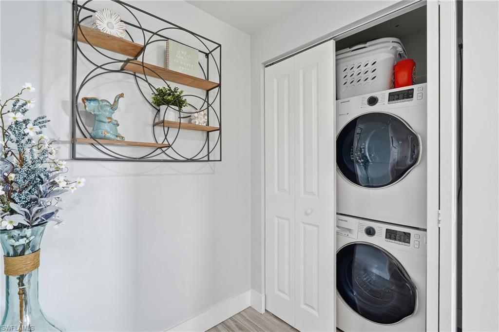 Dedicated laundry closet featuring a stacked washer and dryer - Virtually Edited Image