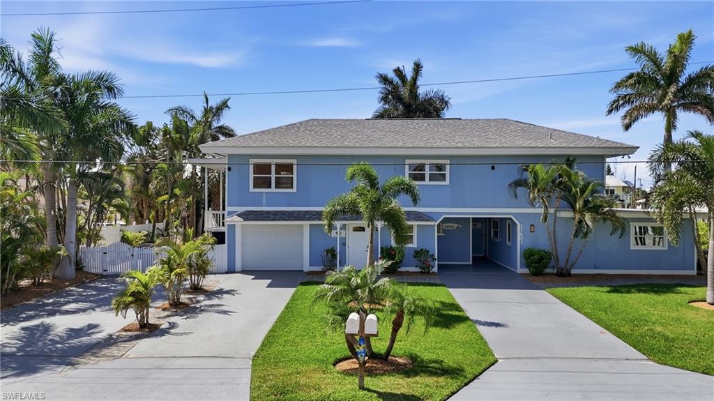 Two-story residence featuring a blue exterior, a gray roof, and white window frames - Virtually Edited Image