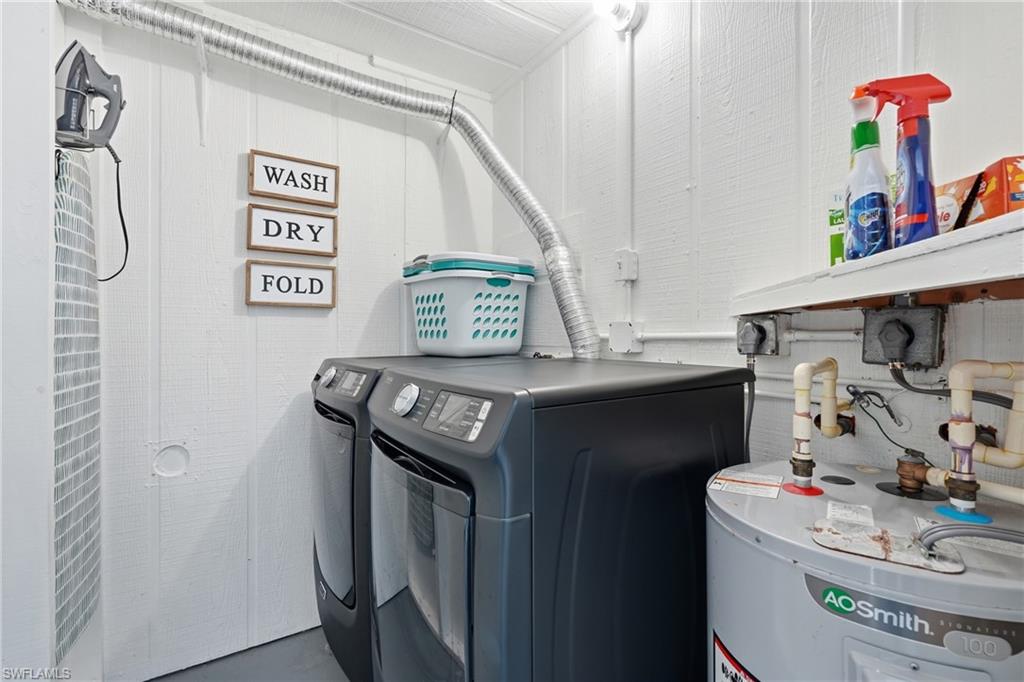 Dedicated laundry area featuring white vertical paneling and a visible water heater - Virtually Edited Image