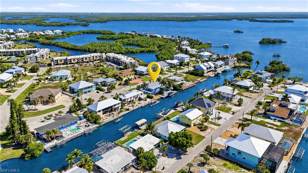 Waterfront property situated on a canal, featuring direct access to open water - Virtually Edited Image