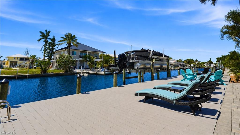 Expansive waterfront dock featuring composite decking and direct canal access - Virtually Edited Image